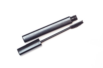 Old black mascara on white background