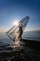 A local fisherman is fishing by boat, Inle lake, Myanmar.