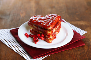 Sweet Belgium waffles with jam, on wooden table background
