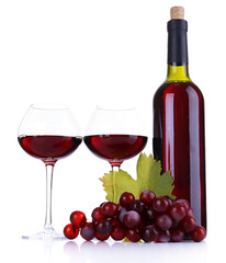 Wineglasses with red wine, grape and bottle isolated on white