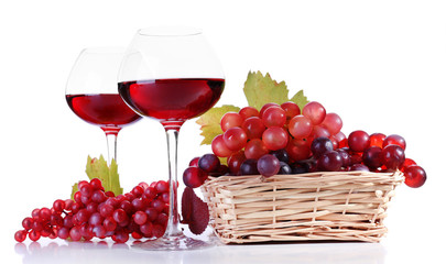 Wineglasses with red wine and  grape in wicker basket isolated
