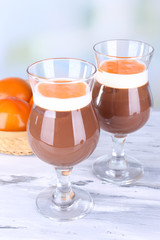 Dessert of chocolate and persimmon on table on light background