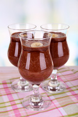 Cocktails with banana and chocolate on table on light