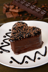 Sweet cake with chocolate on plate on table close-up