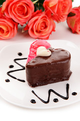 Sweet cake with chocolate on plate close-up