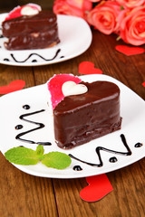 Sweet cakes with chocolate on plate on table close-up