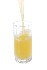 Juice pouring into glass isolated on white