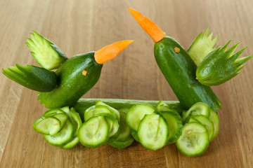 Carving vegetable pattern of hummingbirds on wooden table