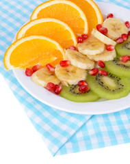 Sweet fresh fruits on plate on table close-up