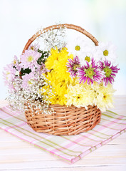 Fototapeta na wymiar Beautiful chrysanthemum flowers in wicker basket
