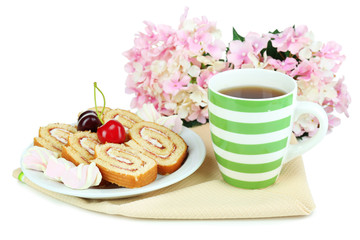 Cup of tea and sweets isolated on white