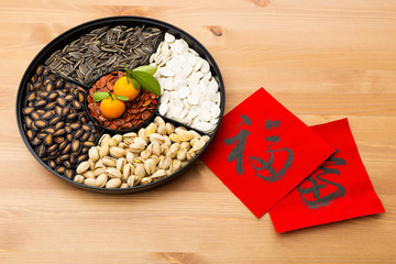 Traditional Lunar new year snack tray and chinese calligraphy, m - obrazy, fototapety, plakaty
