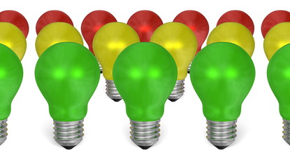 Row of green light bulbs in front of yellow and red ones
