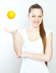 Portrait of a young beautiful woman with orange