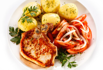 Grilled steak, boiled potatoes and vegetable salad