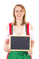 Smiling woman in dirndl holding clean blackboard