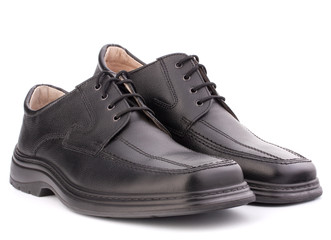 Black glossy man’s shoes with shoelaces