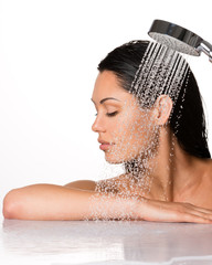 beautiful brunette woman holds shower in hands