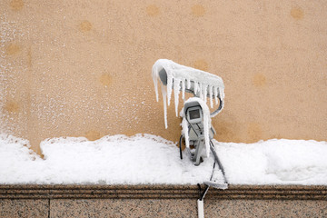 Snow covered video surveillance camera with icicles