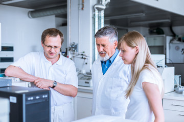 Team of researchers carrying out experiments in a lab