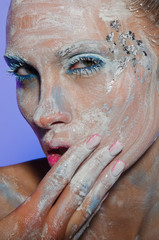 Woman's face smearing colored paint