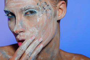 Young woman spreads over face paint