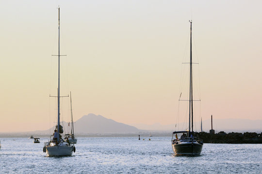 sailboat sailing at sunset