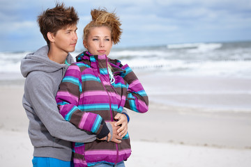 Fototapeta na wymiar Romantic Young Couple On Winter Beach