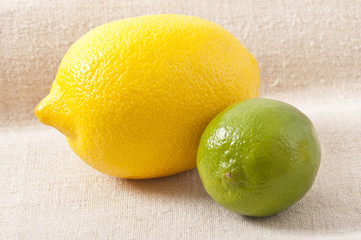 ripe, fresh lemon and lime on a background of old cloth