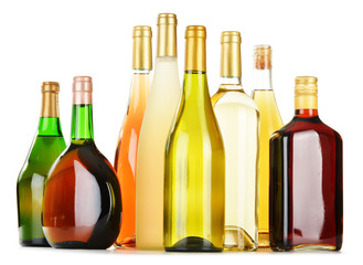 Bottles of assorted alcoholic beverages isolated on white