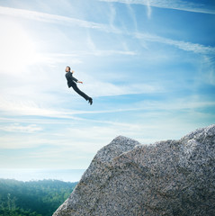 Man in suit flying over mountains