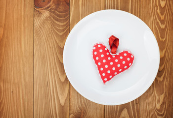 Valentine's Day toy heart over plate