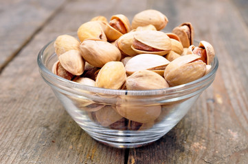 pistachios into a bowl on the table