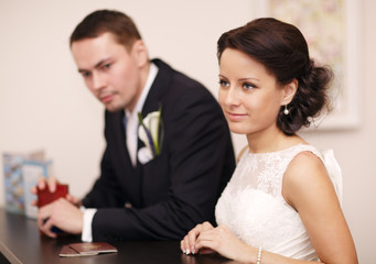 Couple at a reception desk with their passports