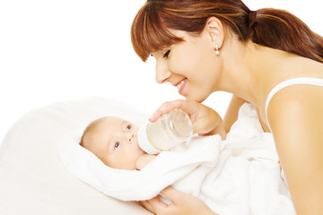 Feeding Baby. Newborn eating milk from bottle.
