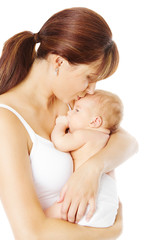Mother kissing newborn baby holding in hand, white background © inarik