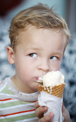 Cute little boy eating an ice cream cone