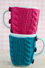 Two blue cups in blue and pink sweater