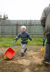 Happy grandson runs with grandfather
