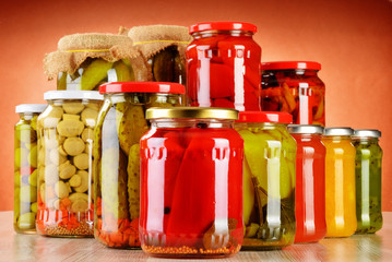 Composition with jars of pickled vegetables. Marinated food © monticellllo