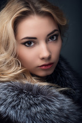 Portrait of young  girl, blonde  in fur coat