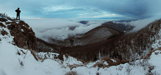 Cloudy mountain at winter with man