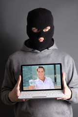 masked man with computer with picture of woman giving money