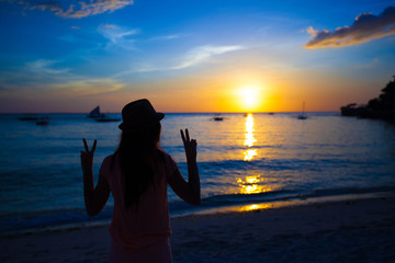 Silhouette of girl at colorful sunset on the island Boracay,