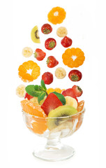 glass bowl with fresh fruits salad isolated on white