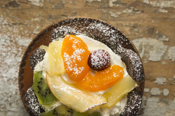Fruit tart in wood plate on old table