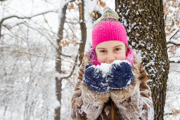 Little girl with snow in hands