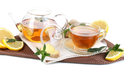Kettle and cup of tea with ginger on napkin isolated on white