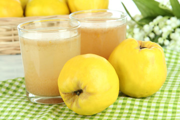 Sweet quince with juice on table close-up