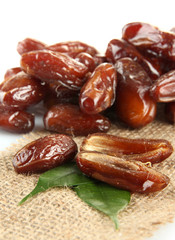 Dried dates on sackcloth isolated on white